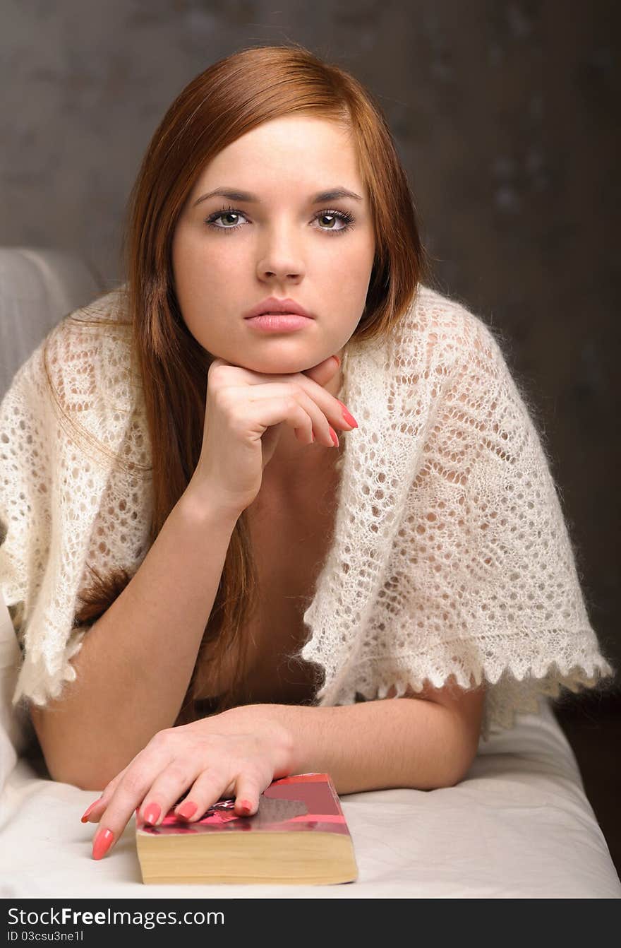 Young woman relaxing on the couch reading a book. Young woman relaxing on the couch reading a book