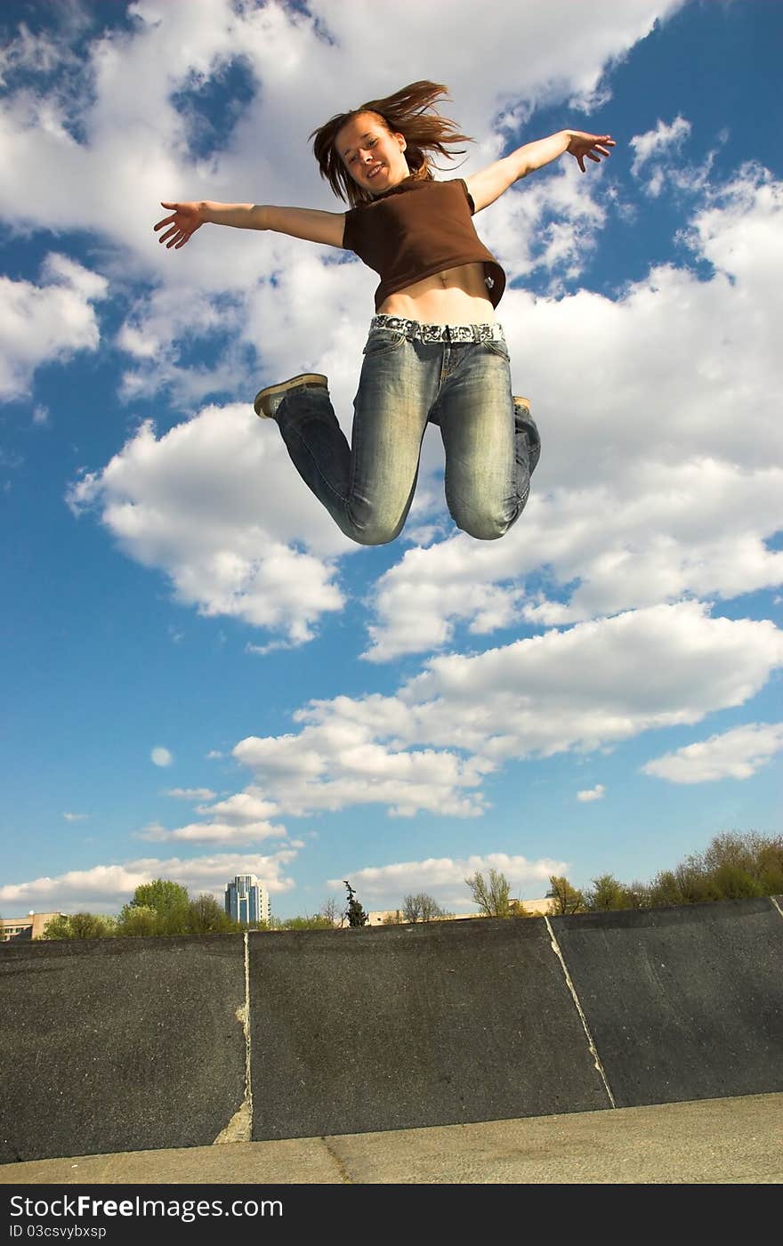 The girl jumps from a fountain.