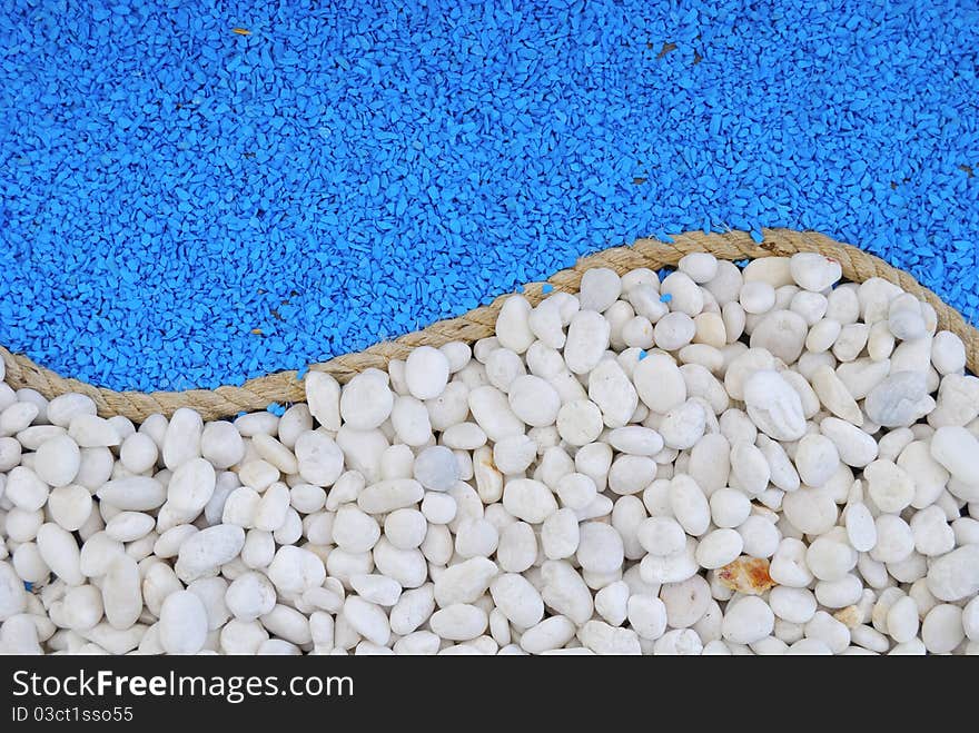 Rope between white and blue stones