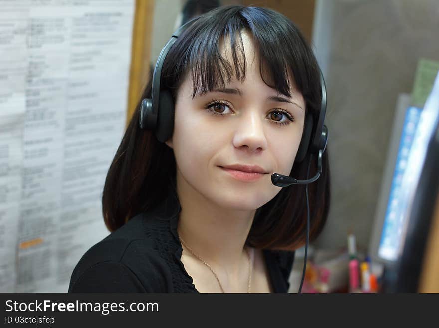 Young beautiful girl telephone operator