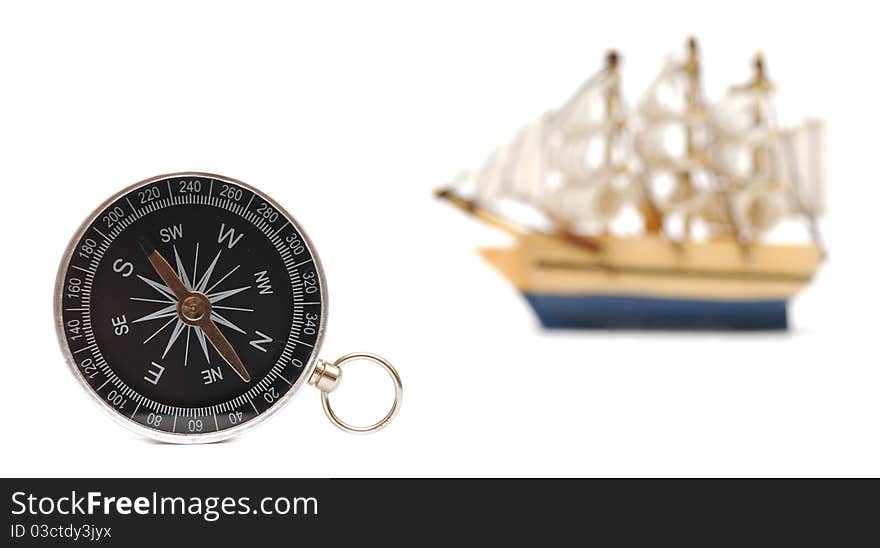 Compass and model classic boat on white background. Compass and model classic boat on white background