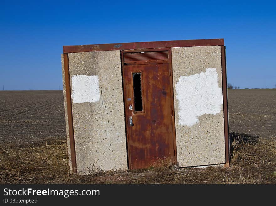 Abandoned pump-house outbuilding on the edge of a field. Abandoned pump-house outbuilding on the edge of a field