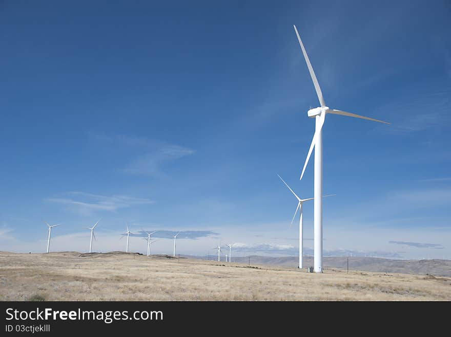 Wind power generators, windmills, in a field in Oregon. Wind power generators, windmills, in a field in Oregon