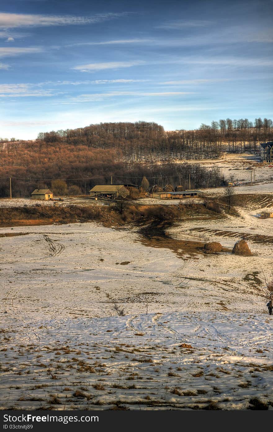 A small farm near sunset towards the end of the winter. A small farm near sunset towards the end of the winter.