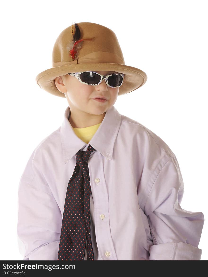 A handsome kindergarten boy with sunglasses, dressing up in Grandpa's shirt, tie and hat. Isolated on white. A handsome kindergarten boy with sunglasses, dressing up in Grandpa's shirt, tie and hat. Isolated on white.