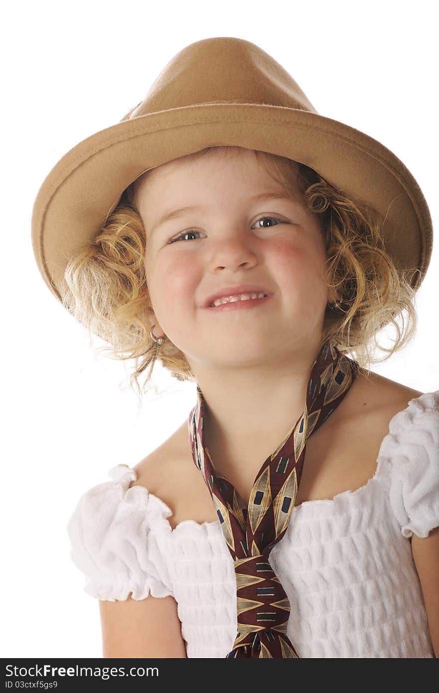 Close-up of an adorable preschooler in a sundress and her grandpa's wide tie and felt hat. Close-up of an adorable preschooler in a sundress and her grandpa's wide tie and felt hat.