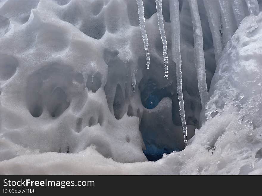 Blue icicles in the snow. Blue icicles in the snow.