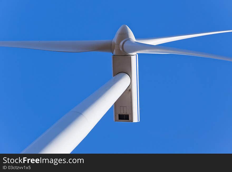 An image of wind turbine against blue sky