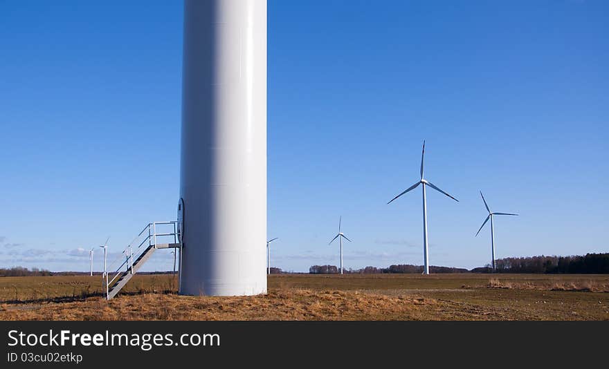 An image of wind turbine against blue sky