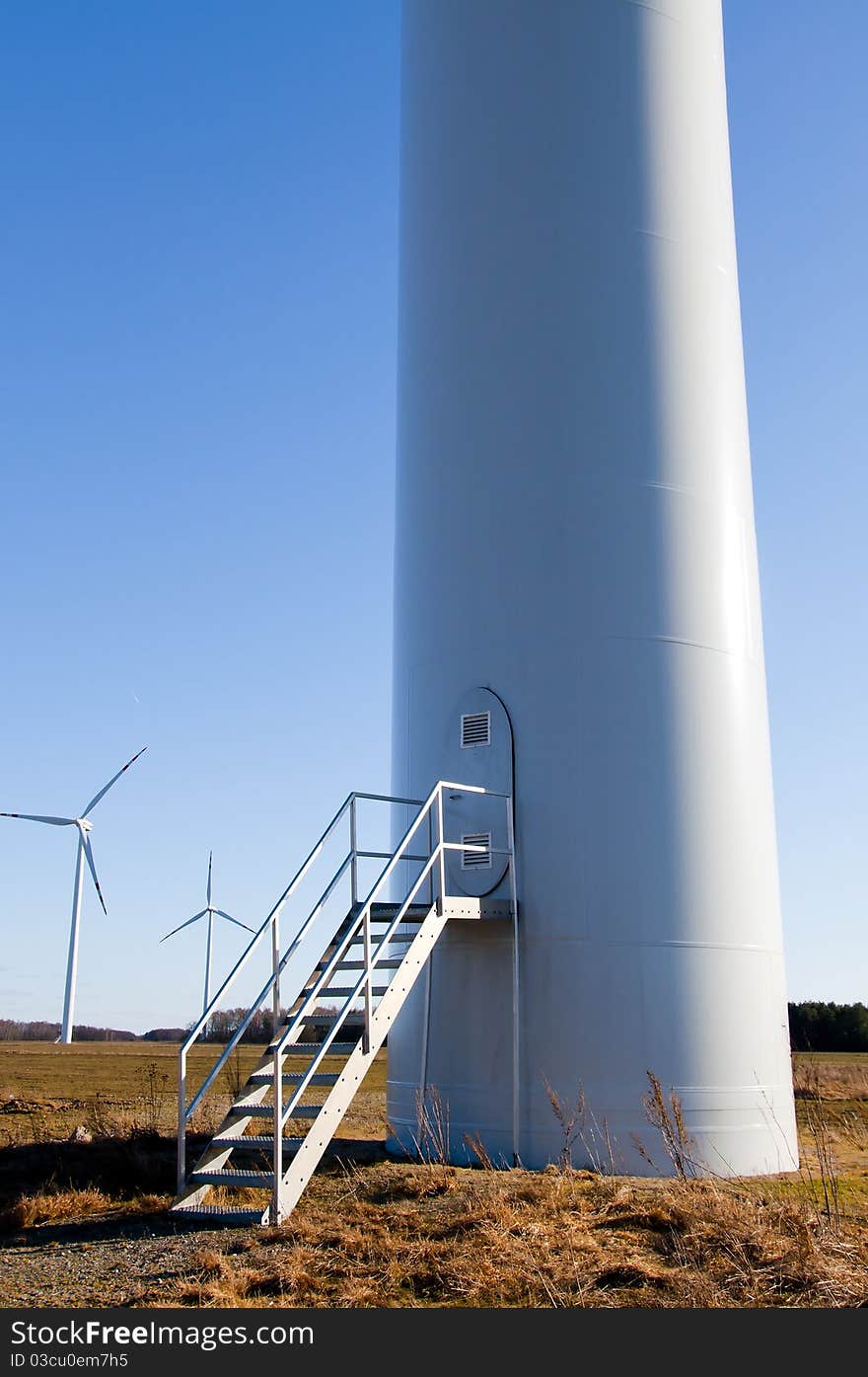 Wind turbine against blue sky