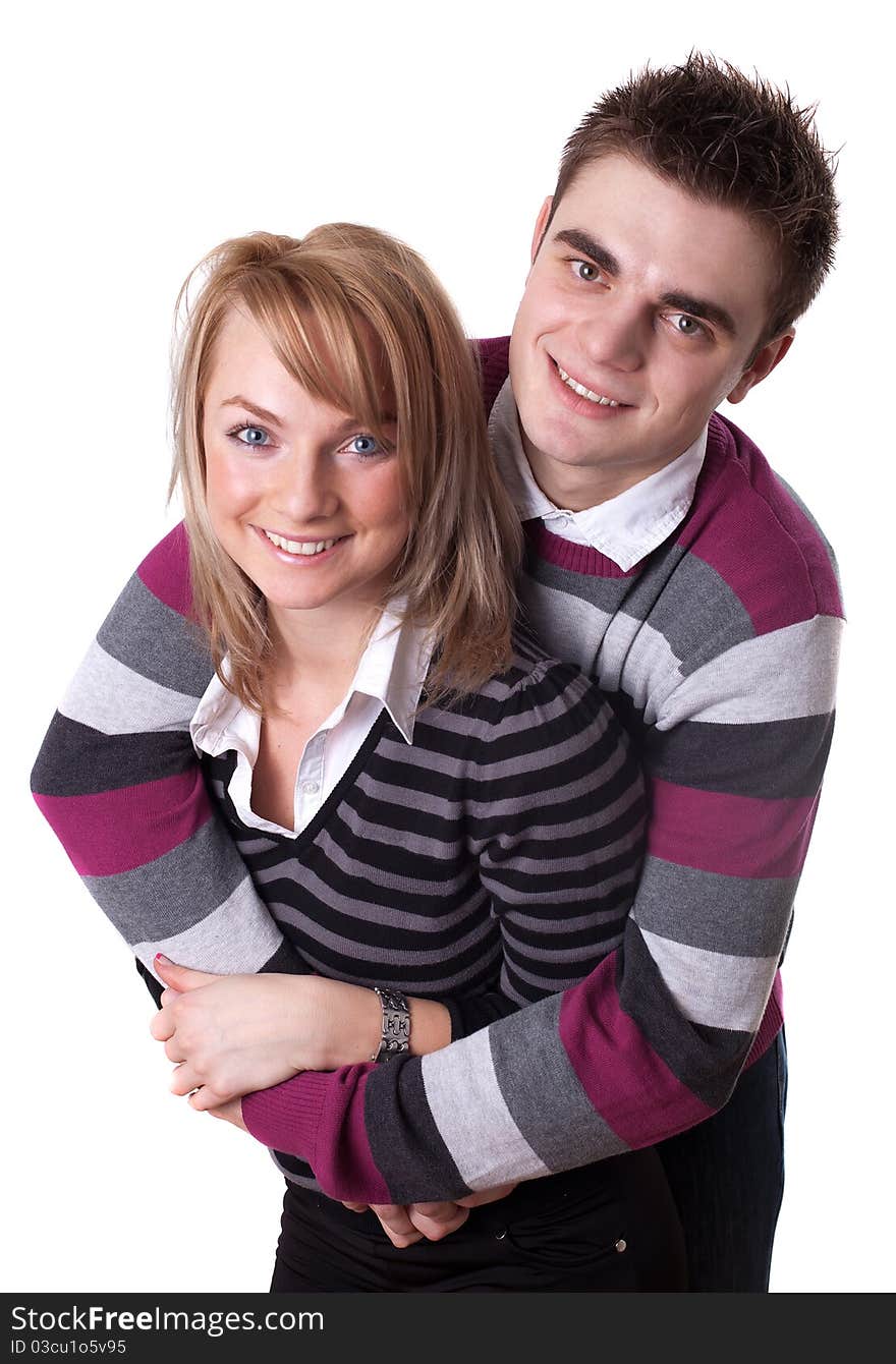 Portrait of a romantic young couple standing together over white background