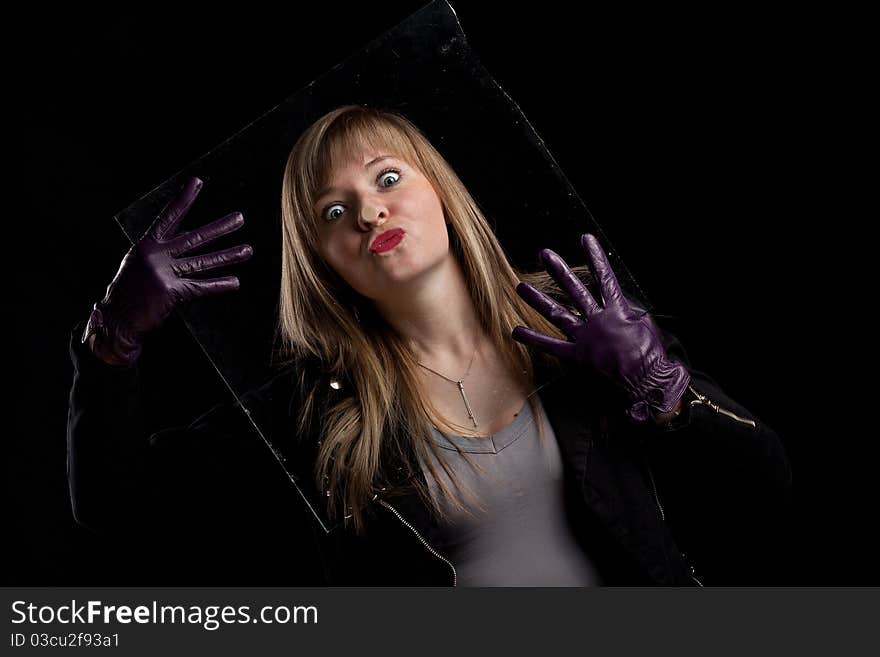 Crazy girl kissing glass, black background