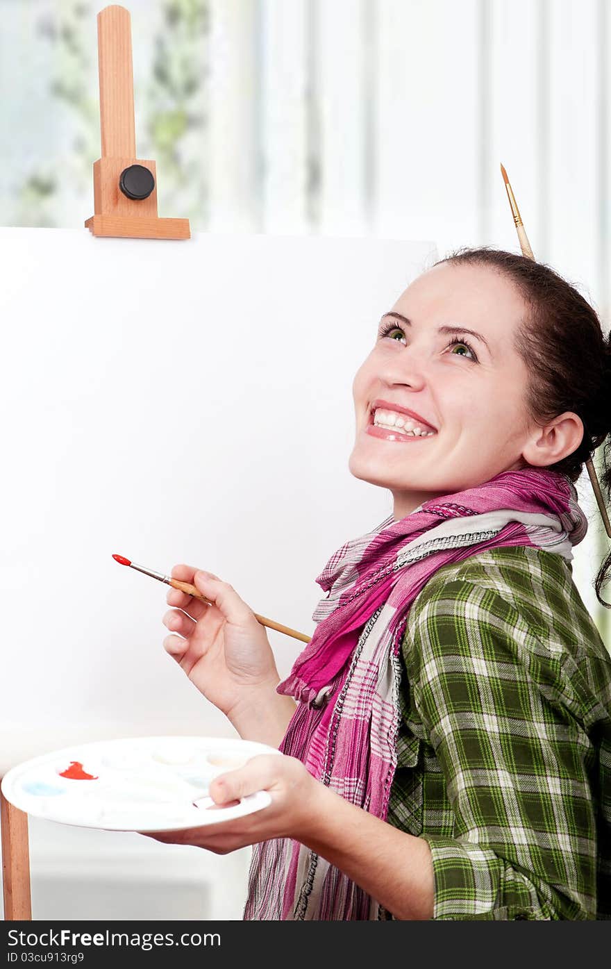 Beautiful girl with brushes near easel, painting on canvas. Beautiful girl with brushes near easel, painting on canvas