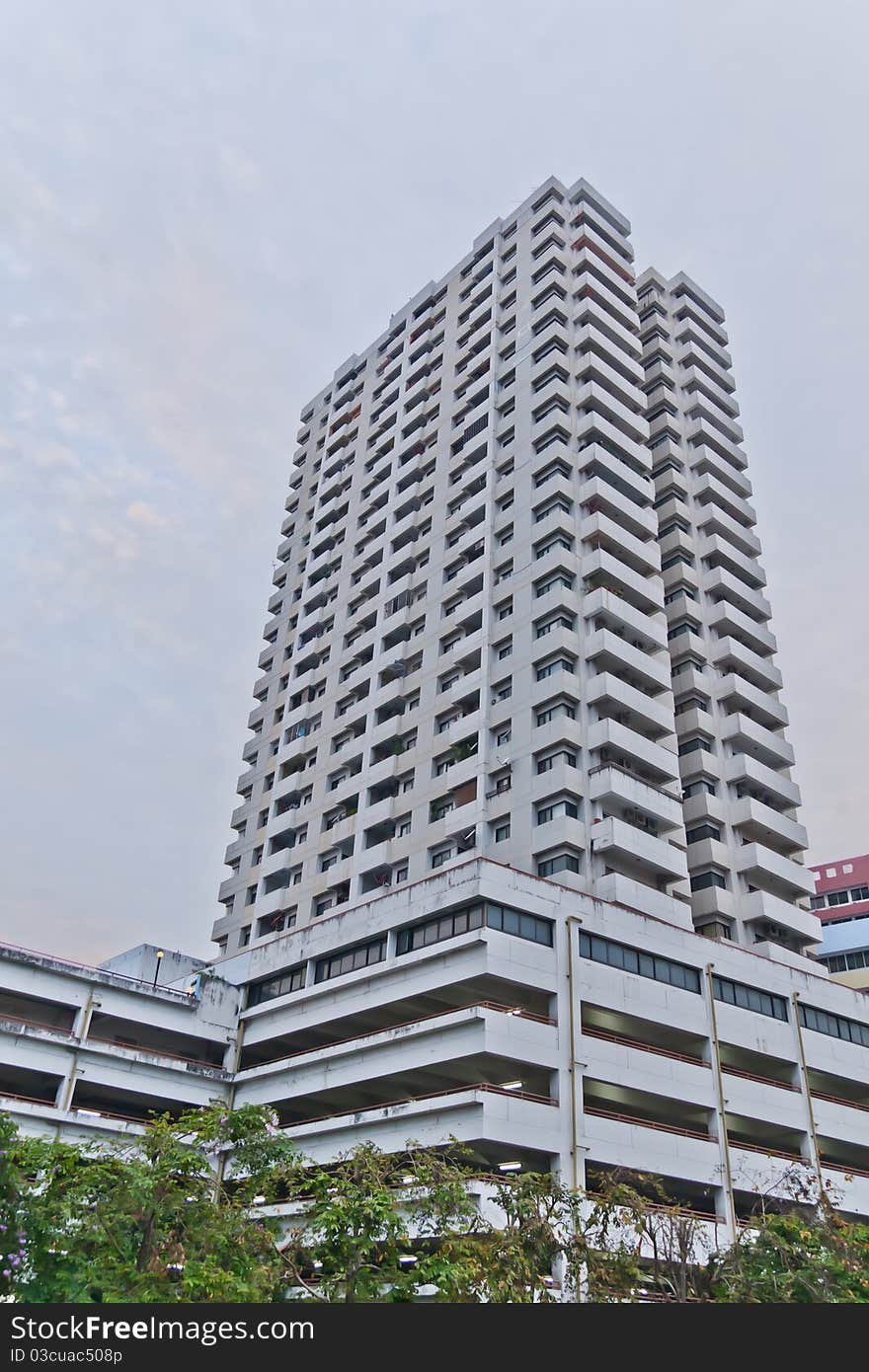 White building with parking underneath the base