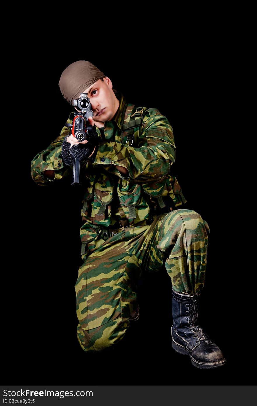 Soldier with weapon, isolated on black background