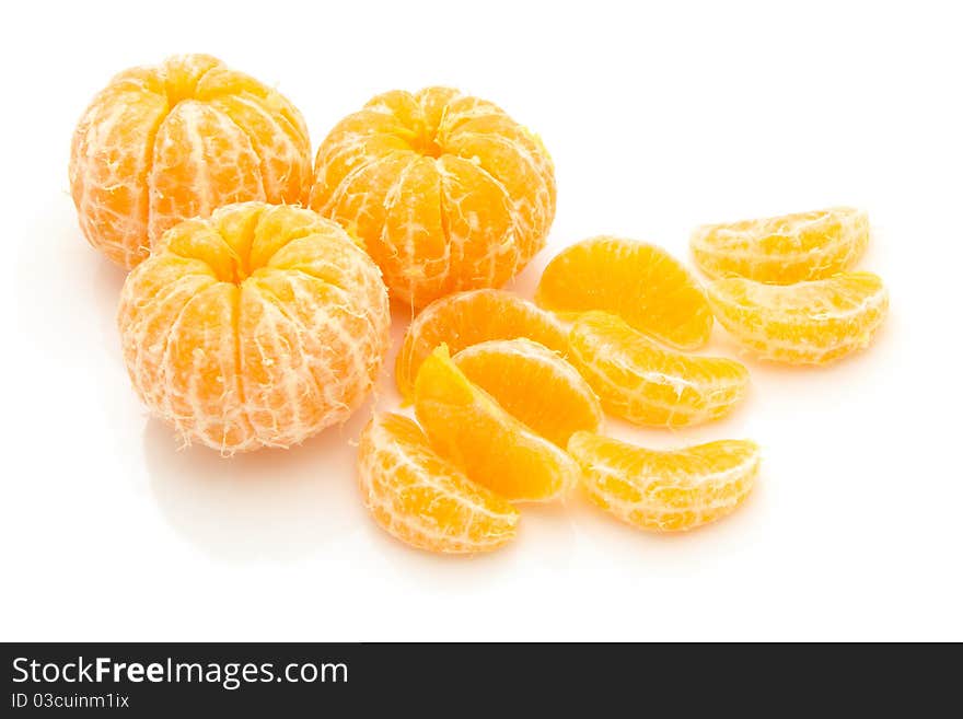 Lices of peeled orange on white background