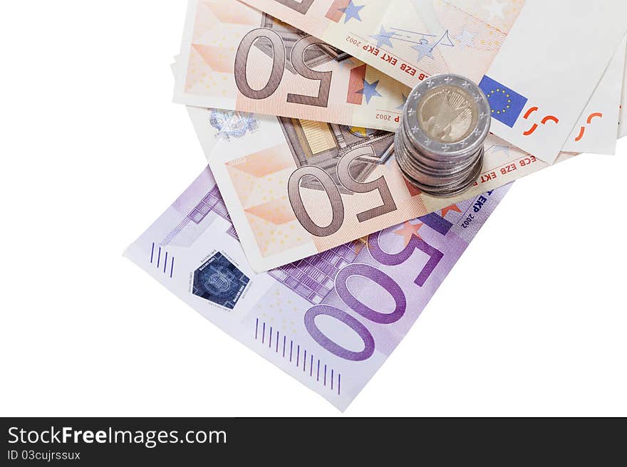 Different euro notes and a stack of coins isolated on white background. Different euro notes and a stack of coins isolated on white background