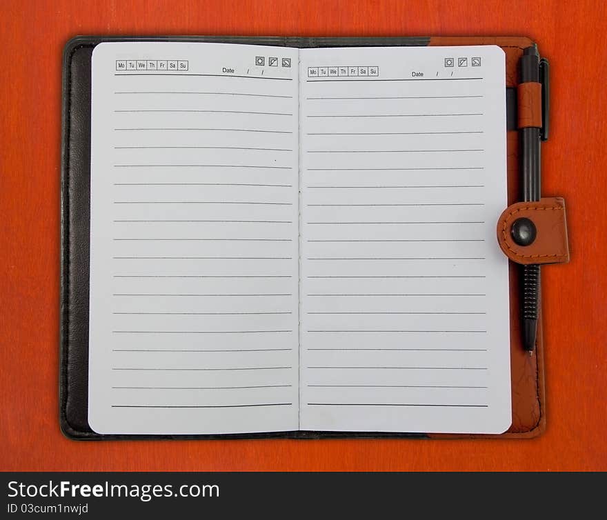 Brown Blank Note Book on wood background