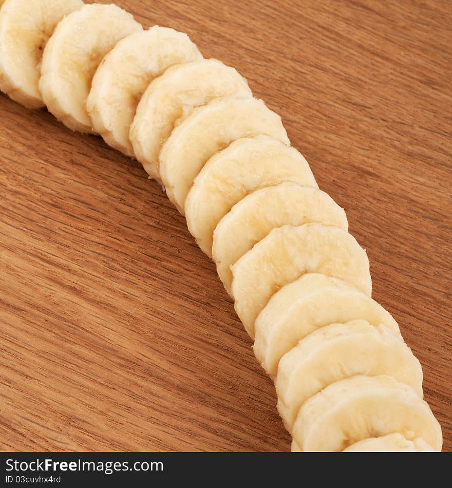 Sliced bananas on a wooden background