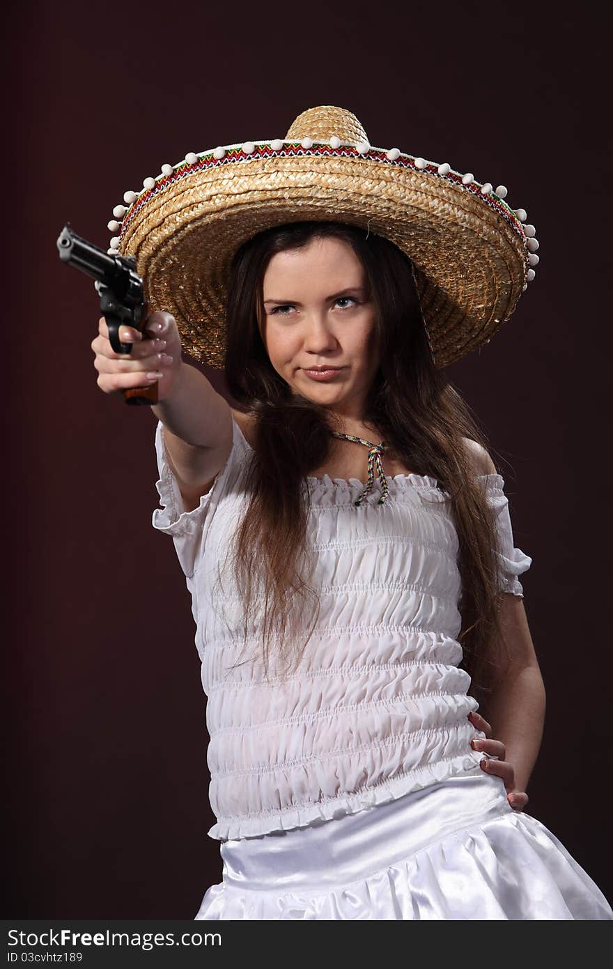 Woman in a mexican costume hold revolver. Woman in a mexican costume hold revolver