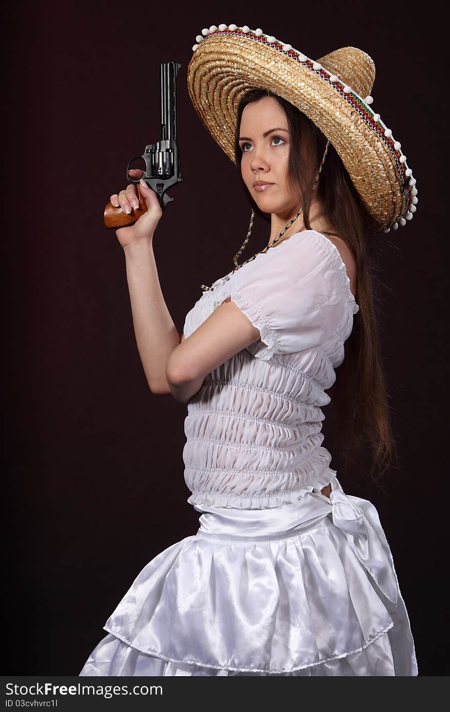 Woman in mexican costume hold revolver. Woman in mexican costume hold revolver