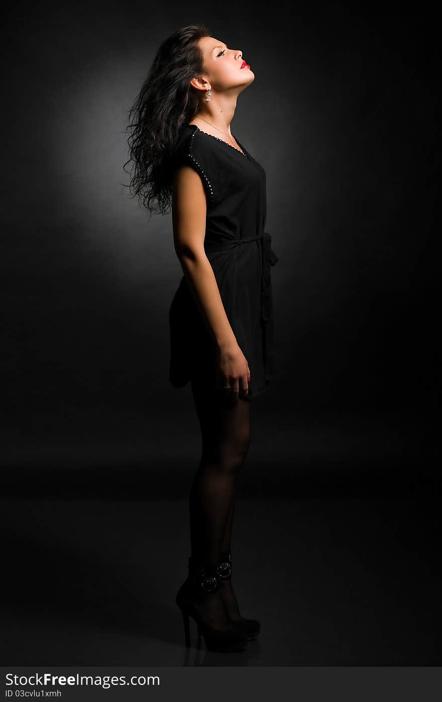 Art fashion photo of young woman on black