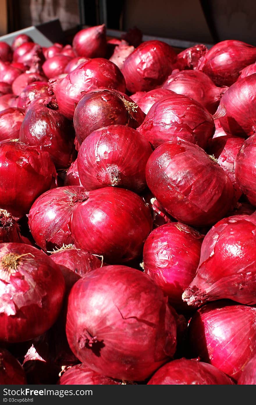 Organic red onions in the marketplace