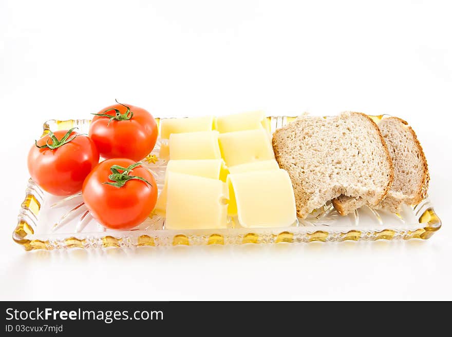 Picture of tomatoes, cheese, and some bread on a glass plate. Picture of tomatoes, cheese, and some bread on a glass plate.