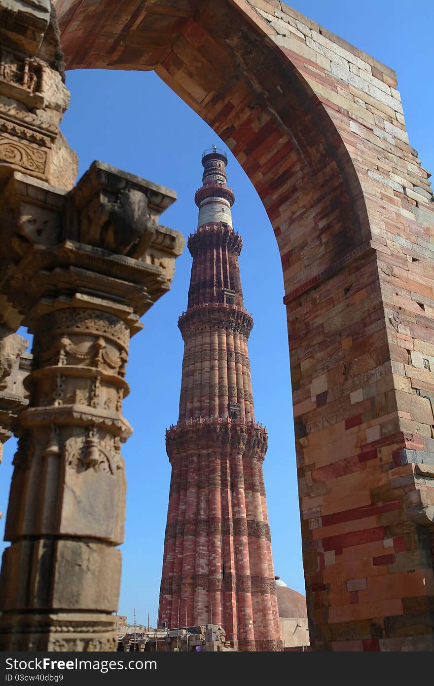 The qutub minar seen through an arch