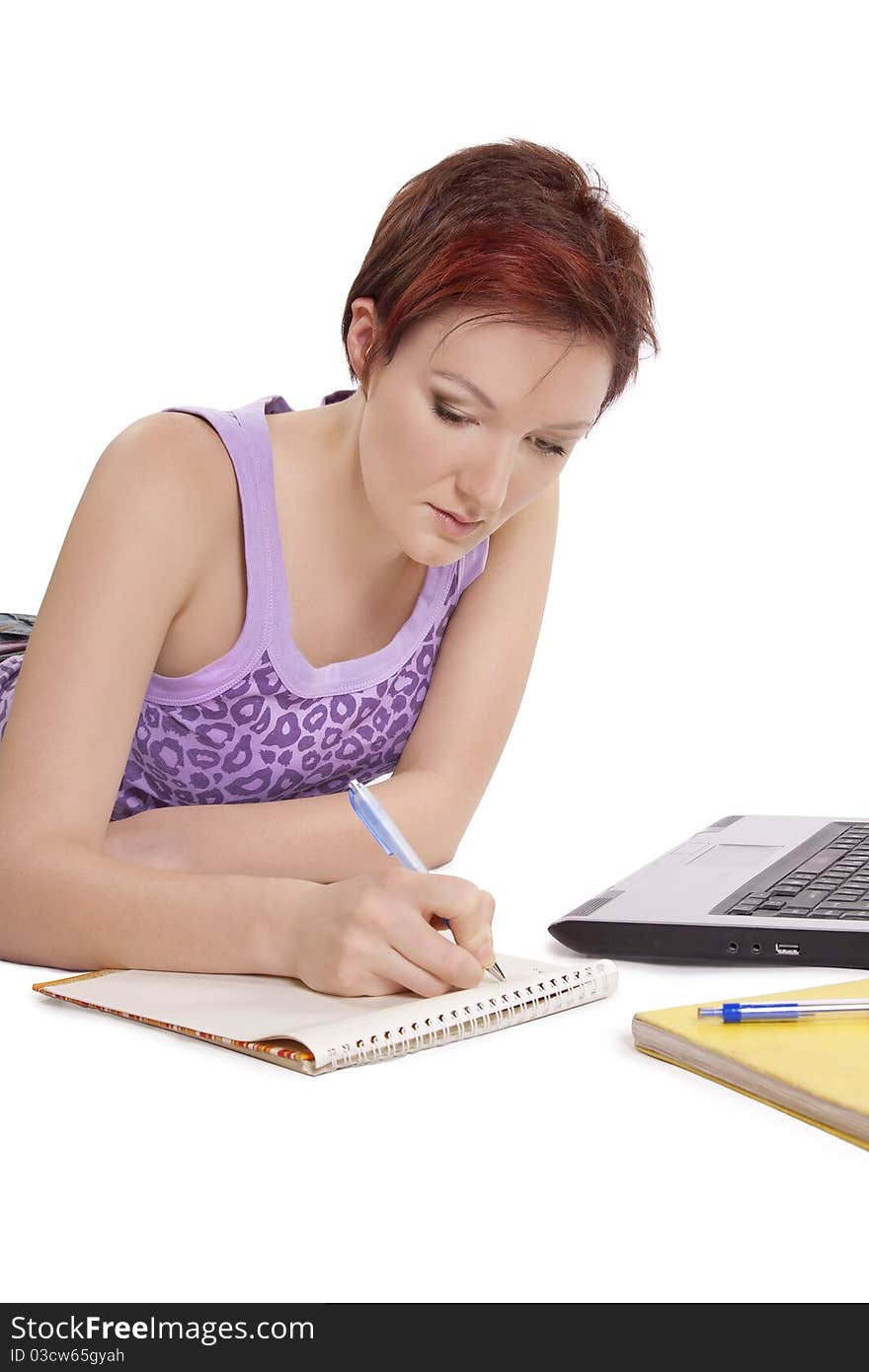 Girl doing her homework on white background.