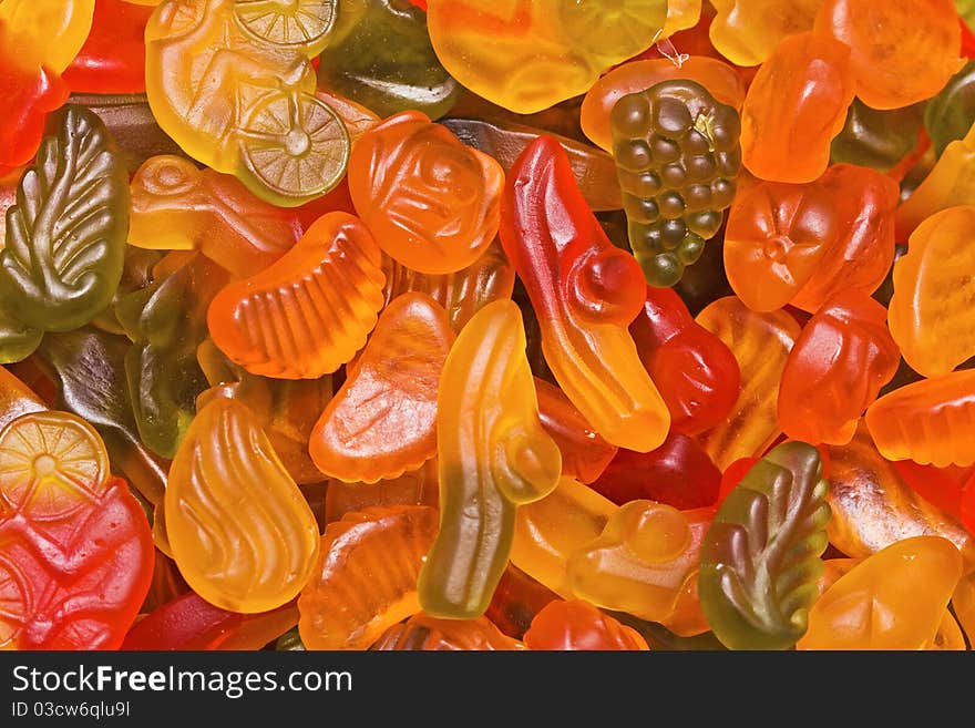 Bright fruit candy of the different form, motley background