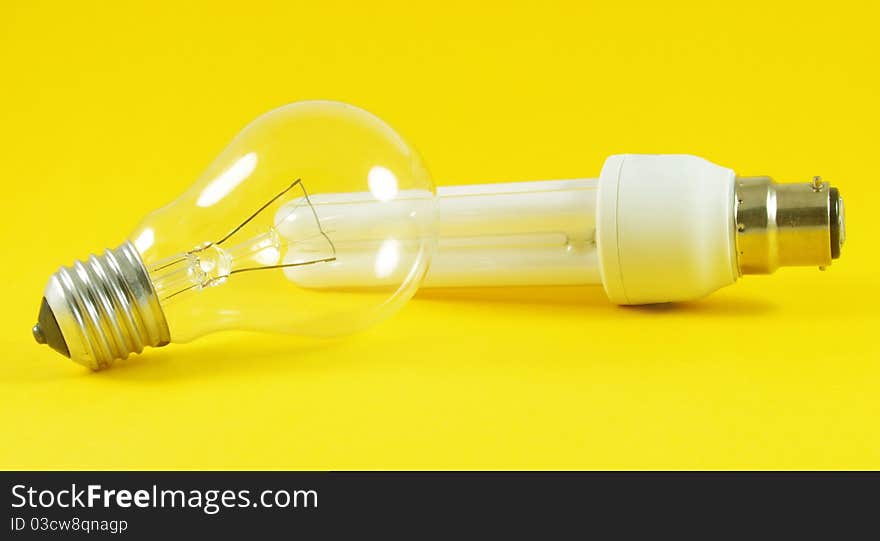 Economic and regular light bulbs over yellow background. Economic and regular light bulbs over yellow background