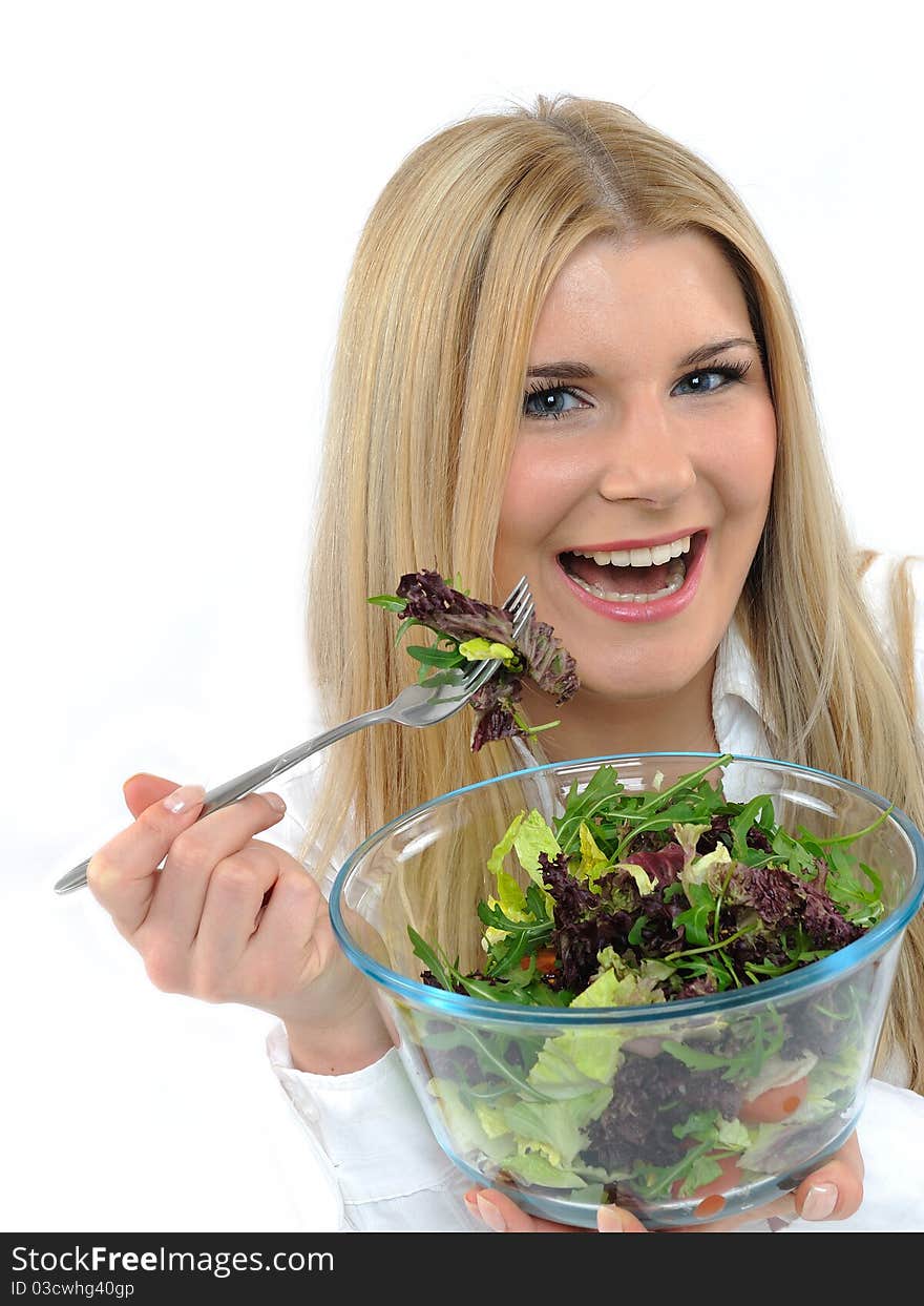 Pretty woman eating green vegetable salad