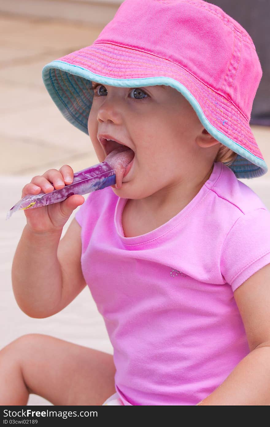 Young toddler enjoying an ice block. Young toddler enjoying an ice block