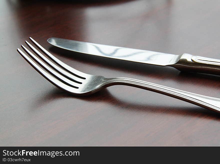 Fork and spoon isolated on dining table