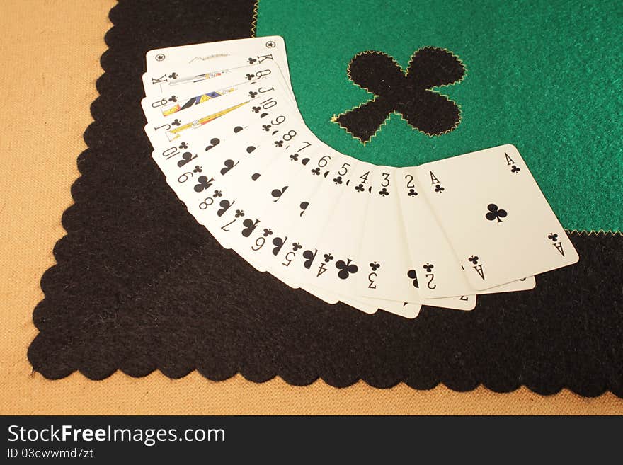 Game table made ​​of wood, fabric tablecloth, flower sign , wall-scale poker.