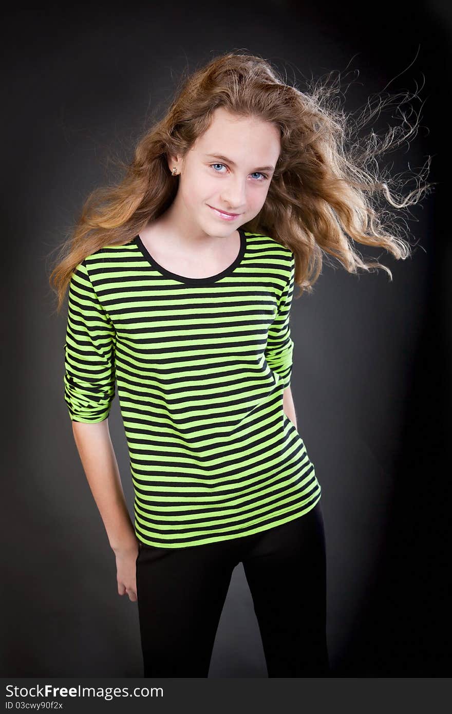 Portrait of a beautiful girl in the black background