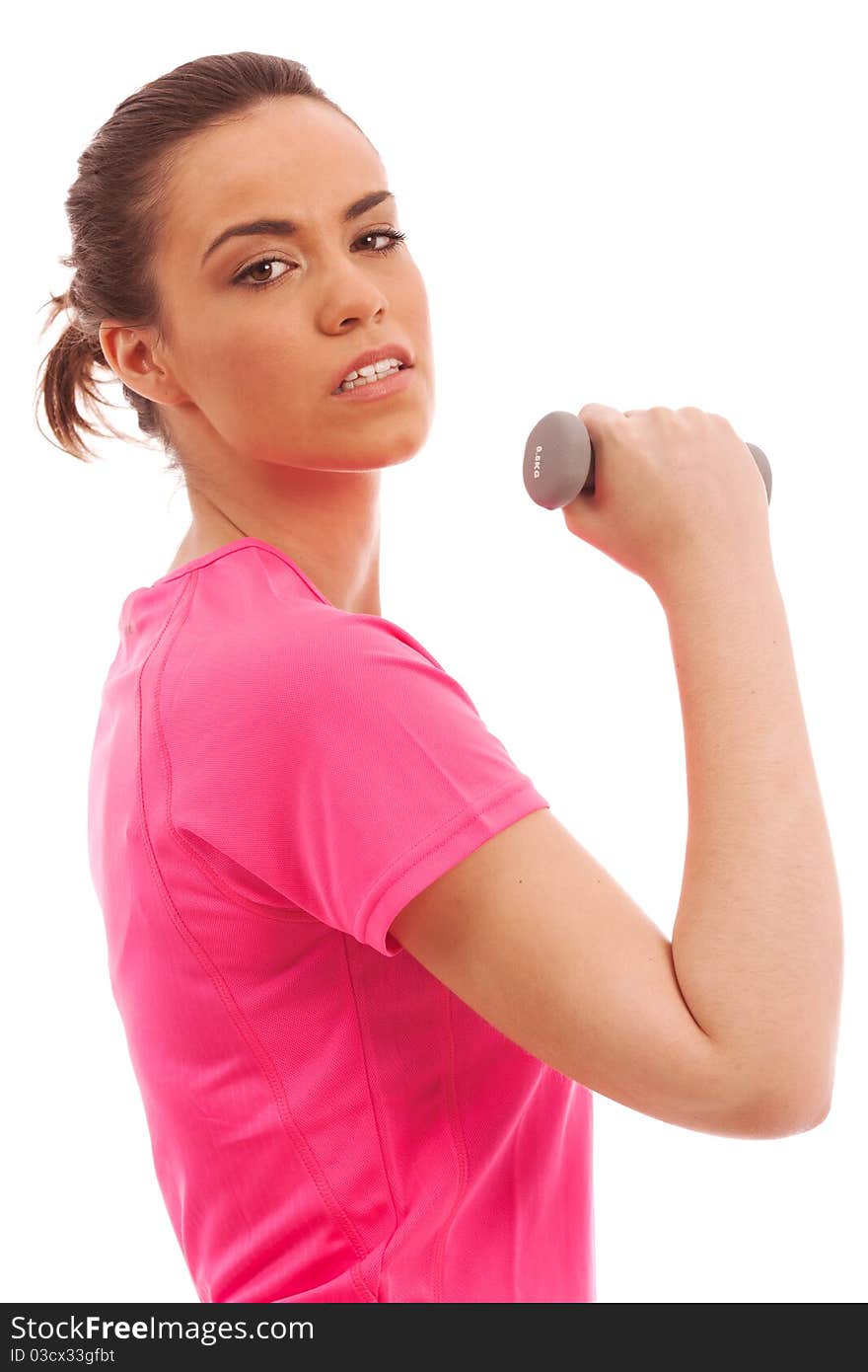 Young girl in a pink top performing an arm curl with a weight. Young girl in a pink top performing an arm curl with a weight