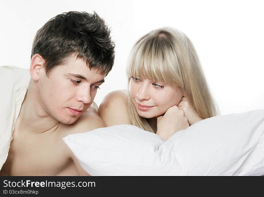 Young couple in bed over white