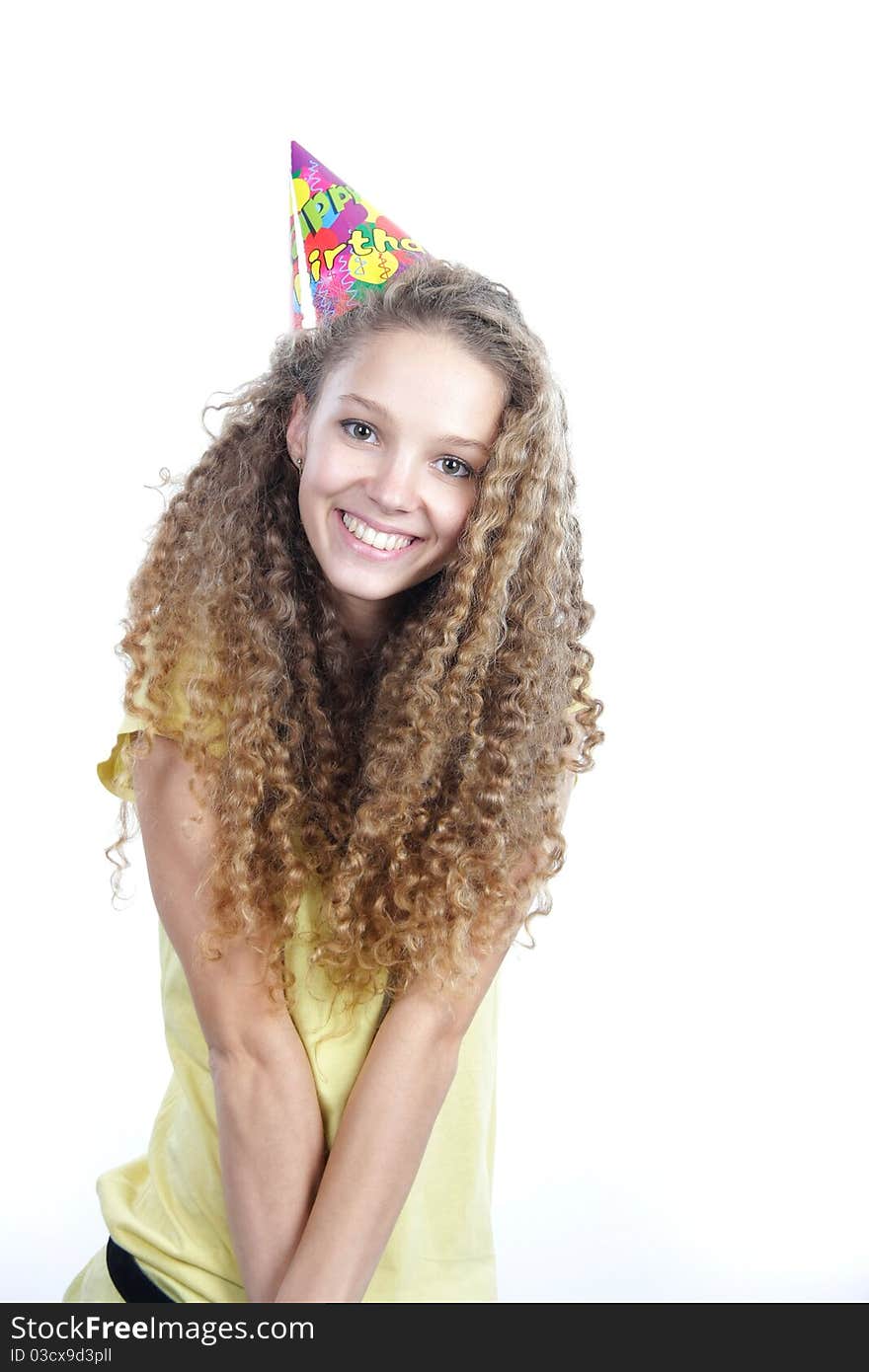 Young smiling woman in birthday hat over white