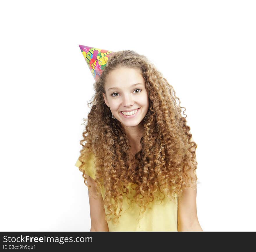 Young smiling woman in birthday hat over white