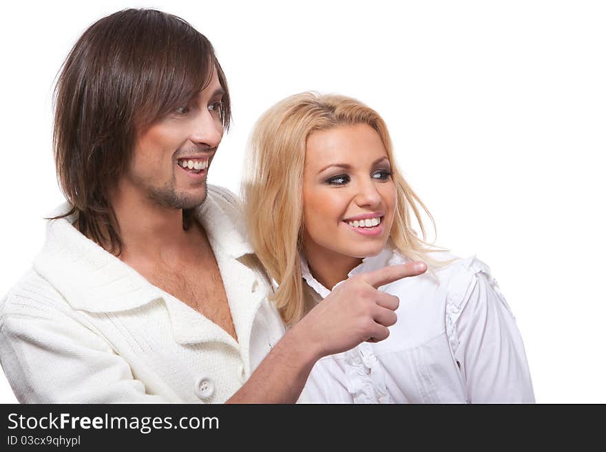 Young happy smiling couple pointing at something