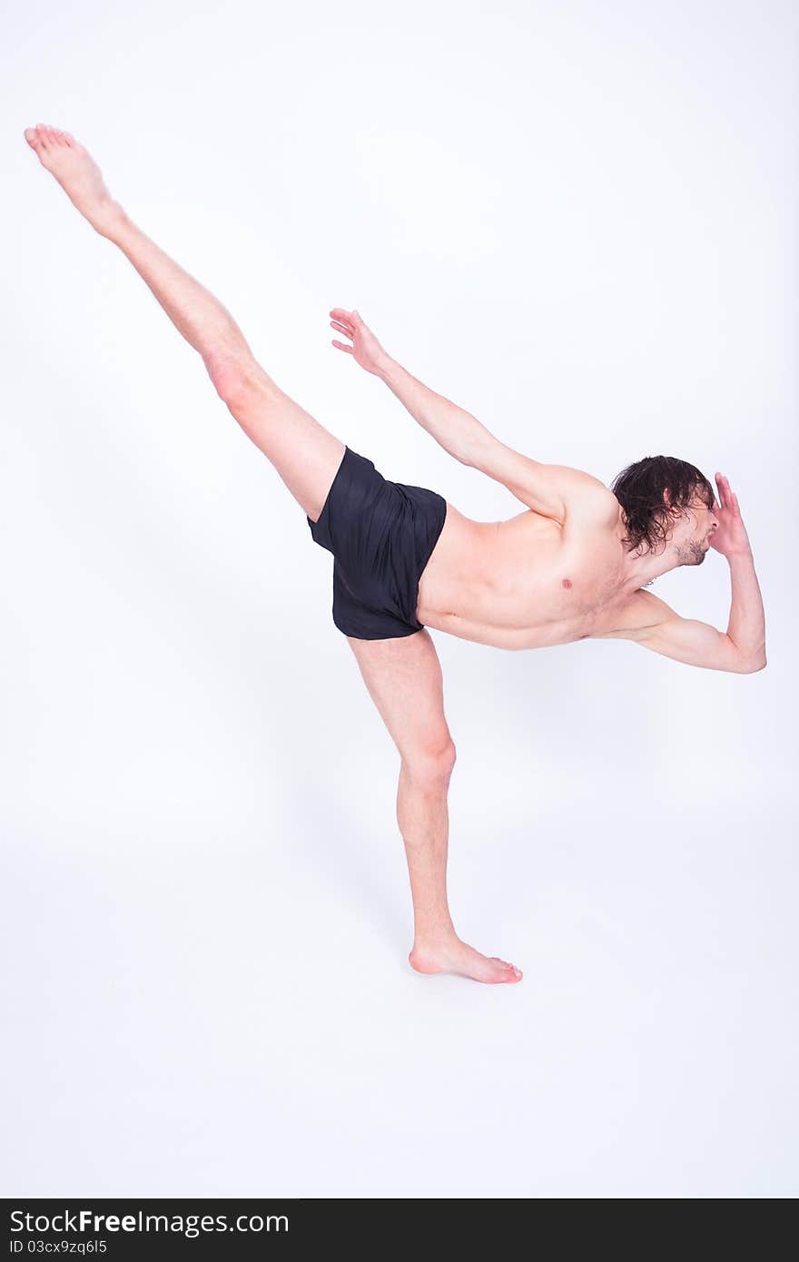 Young attractive man dancing passionate contemporary in studio