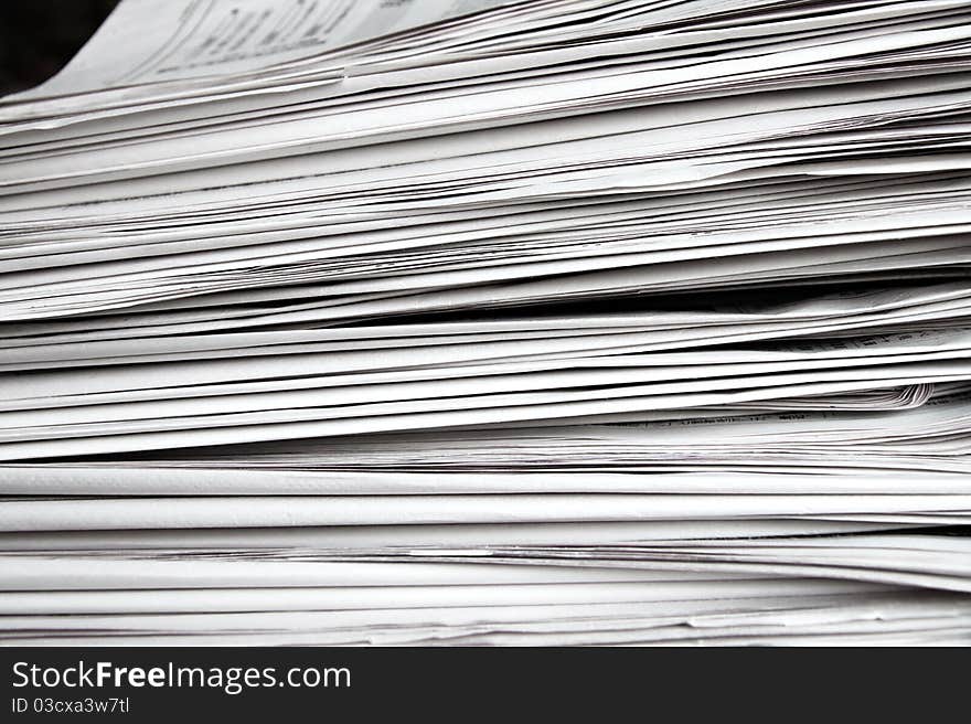 Stack of white newspapers, closeup.