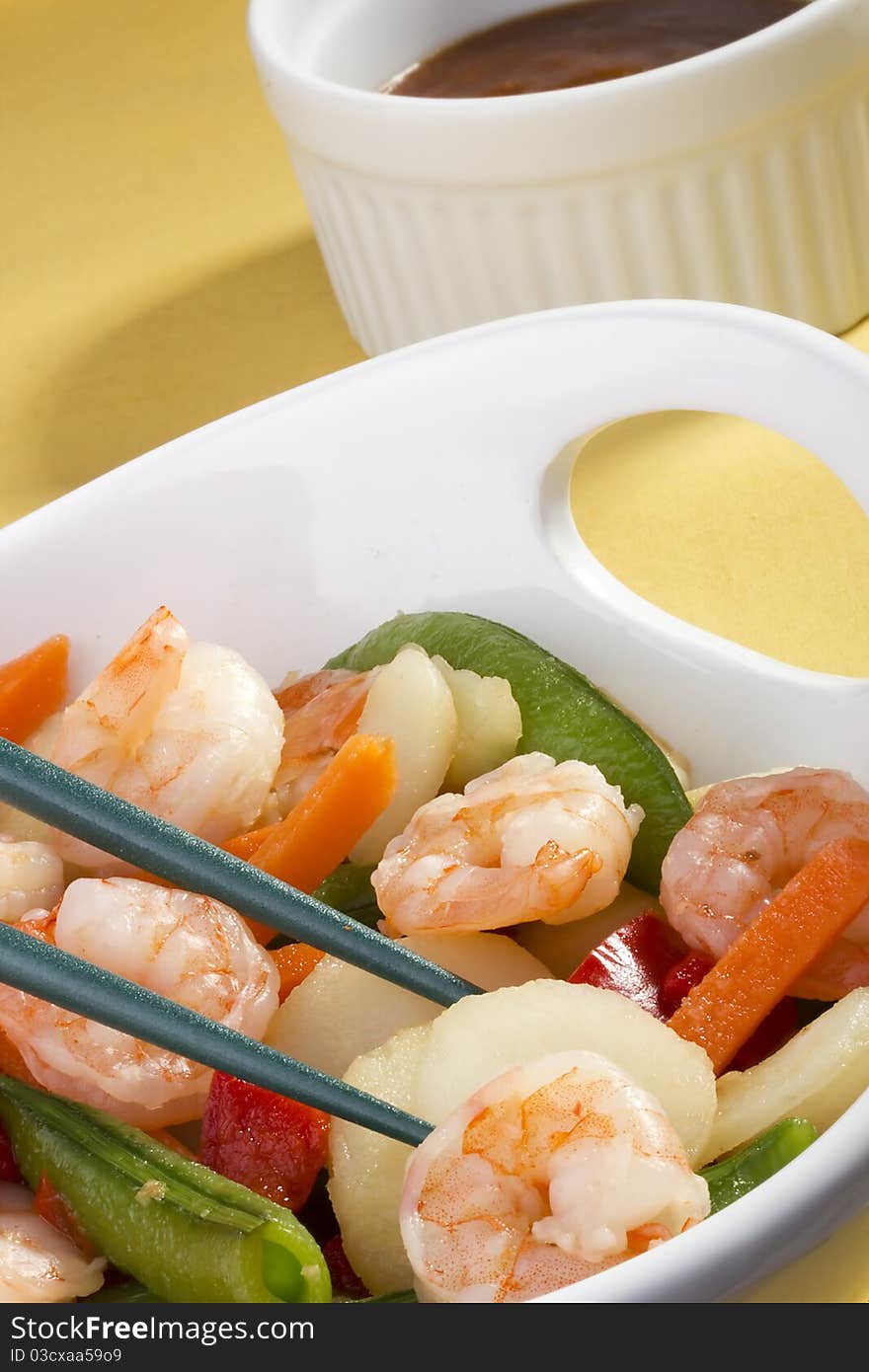 Asian salad in a white bowl with green chopsticks. Asian salad in a white bowl with green chopsticks.