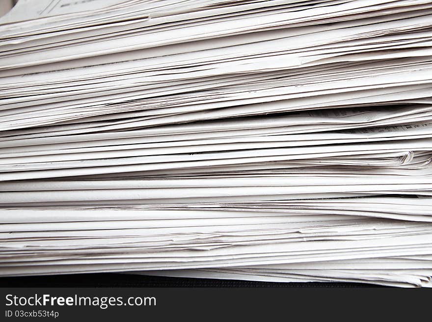 Stack of white newspapers, closeup.