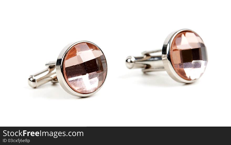 Pair of platinum cufflinks with a pink stone isolated on white background