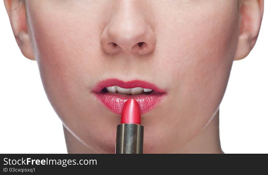 Woman applying lipstick isolated on white