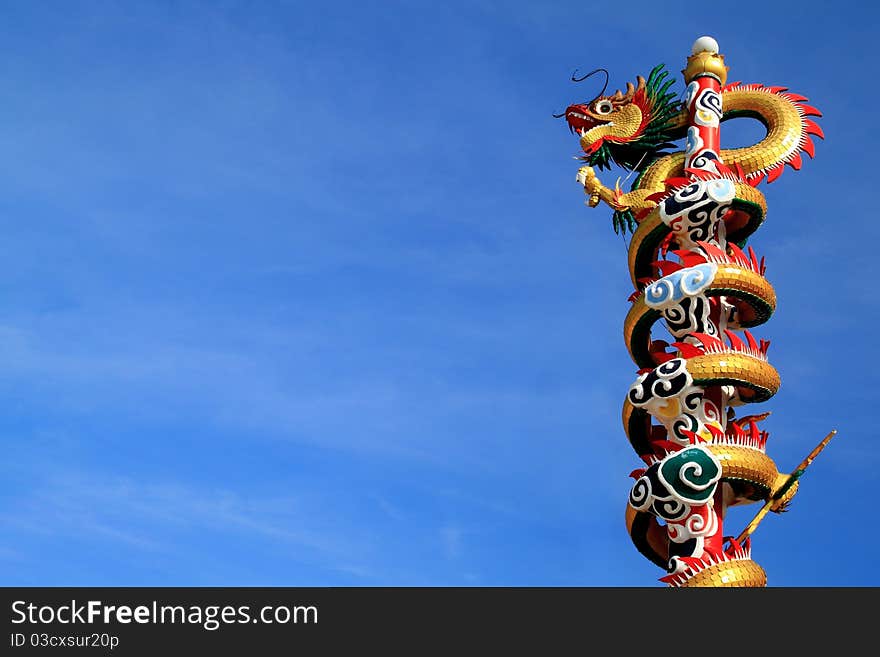 Dragon climbing pole and blue sky