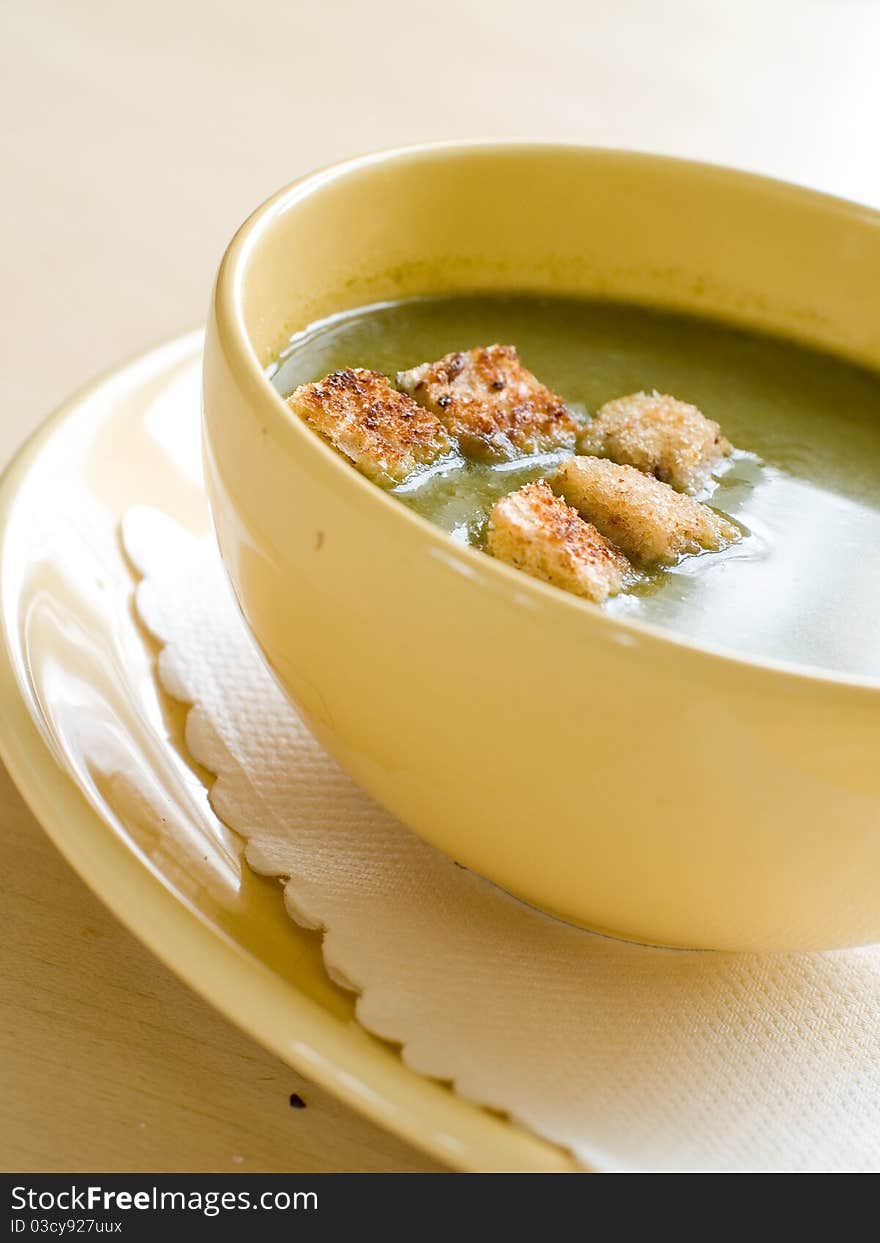 A bowl of homemade spinach soup with crouton and parsley Selective focus